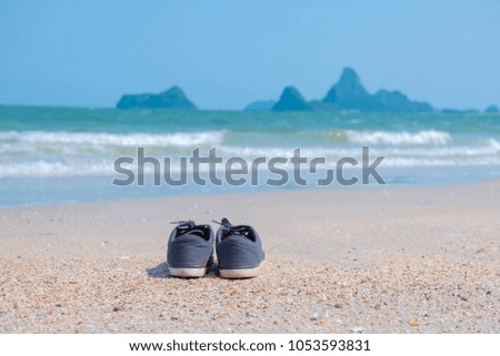 summer concept picture of shoes beside  white beach. 