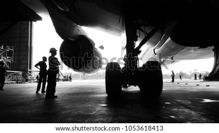 Aircraft push back into the  maintenance area.Aircraft(airplane)in aircraft hangar for maintenance service check by aircraft technician.Maintenance before flight. Royalty-Free Stock Photo #1053618413