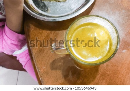 Kid having breakfast at home with glass of effervescent Vitamin C tablet to prevent common cold