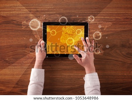 Caucasian business hands holding tablet with orange business-statistics screen