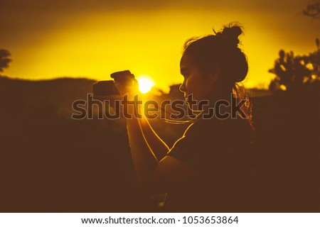 female asian traveler photographer 
 landscape outdoor Silhouette at sunset  Young woman.