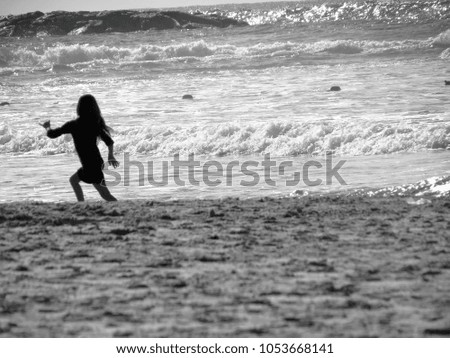 Young Girl Runs on the Coast in Sunset. Black and White Picture in Nature.