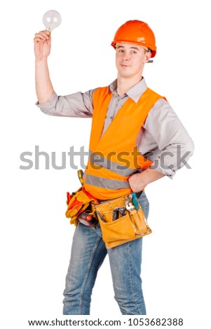portrait of a male builder in a helmet over white wall background. repair, construction, building, people and maintenance concept.
