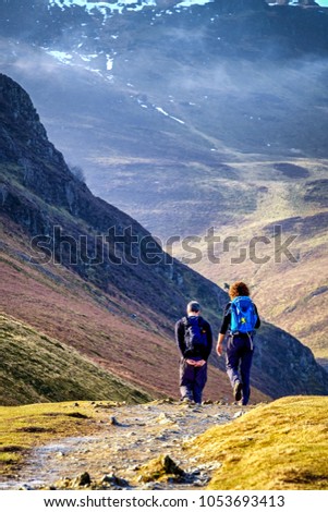 Walkers on mountain path, Lake District,  Royalty-Free Stock Photo #1053693413