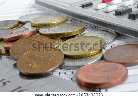 Financial background with different coins, ruler and table.