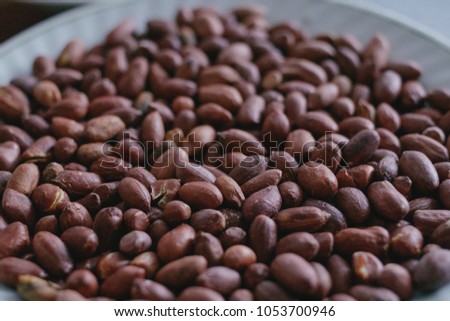 Roasted peanuts in a plate. Close-up.