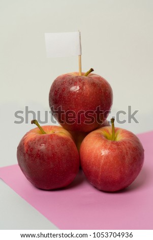 Red apple on white and pink.