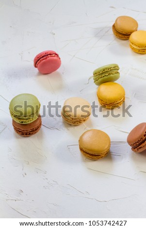 Macaroons isolated. Blue, rose and baige colors. White plate, white background. 