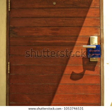wooden door with a hanging sign (Do not disturb)