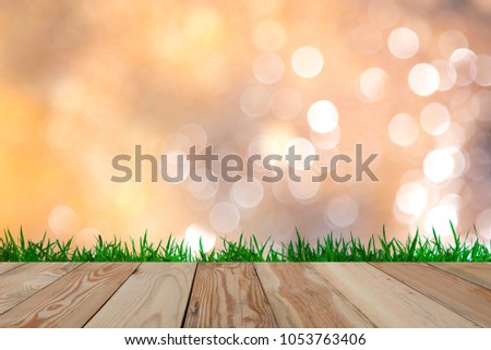 Background image blur Beautiful bokeh with wooden space and grass.