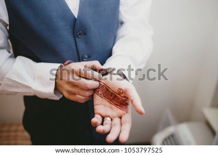Man Showing henna design on his palm