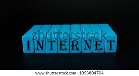 Word on wood block in black background. Concept business online.