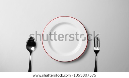 Plate with spoon and fork on white table _isolated background stock photograph with copy space free image