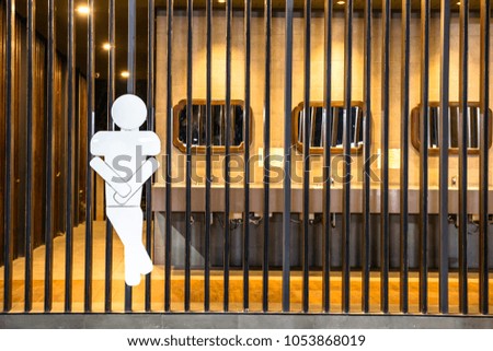 Men bathroom symbol on the wood wall and lighting background with Toilet

