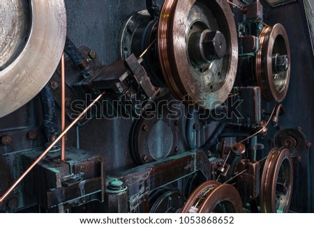 Copper round rollers for rolling wire. Fragment Wire drawing equipment. Abstract industrial background. Royalty-Free Stock Photo #1053868652