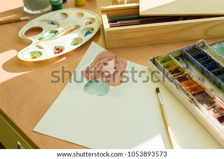 Drawing by watercolor - anime girl, on a table with watercolor paint brush