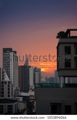 scenic of sunrise twilight sky with urban cityscape building background