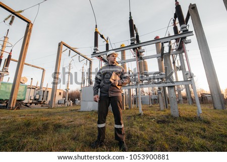 The energy engineer inspects the equipment of the substation. Power engineering. Industry. Royalty-Free Stock Photo #1053900881