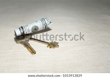 The key to success with a roll of cash banknotes on the table