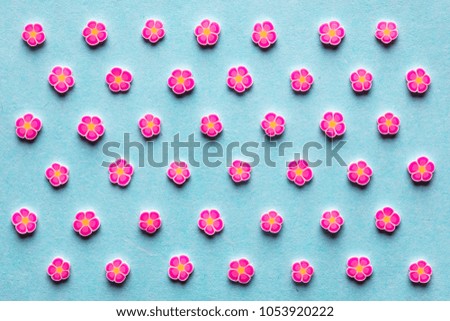 pattern of pink flowers topping on light blue background
