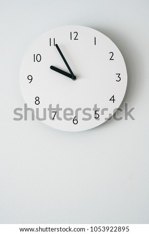 white clock on white backgrounds wall