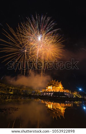 Fireworks celebrate the New Year 2018 at Rajapruek Royal Park, Chiang Mai with beutiful light of Hor Khum Luang temple,Thai Tradition Building.