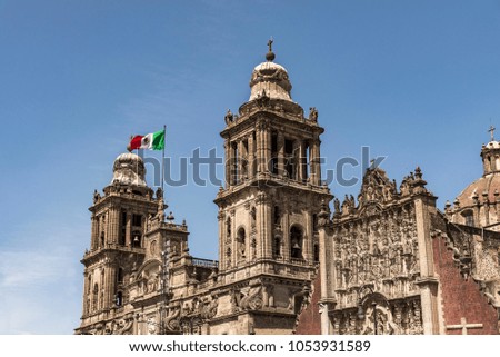 Mexico City Cathedral with Mexican Flag, view from below ,blue sky background