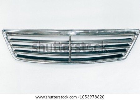 Chrome grille facing the radiator. This part of the car body.