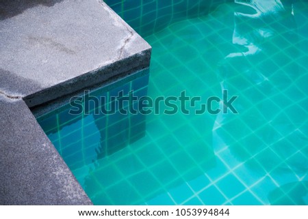 Swimming Pool Cement Edge. Clear blue water, see the tile in the pool.