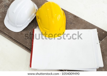 yellow and white helmet on  plan in white construction room
