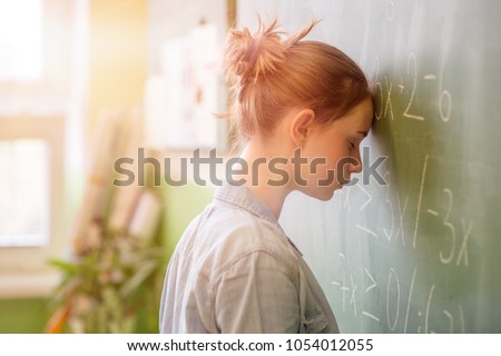 Teenager girl in math class overwhelmed by the math formula. Pressure, Education, Success concept. Royalty-Free Stock Photo #1054012055