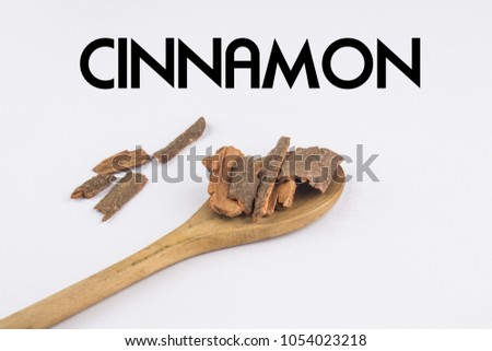  Cinnamon in wooden spoon isolated on white background