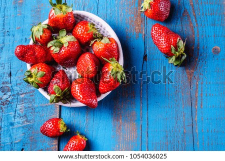 Red ripe juicy strawberries on  wooden  background, closeup, top view.