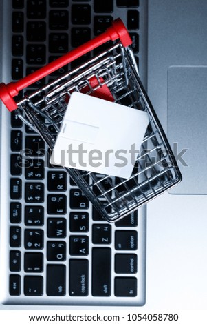 white card in food basket on laptop keyboard.mock up