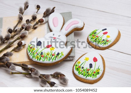 Easter gingerbread set and willow twig on white wooden background.  Easter Bunny and eggs, gingerbread 