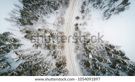 Aerial view of a winter road. Winter landscape countryside. Aerial photography of snow forest. Captured from above with a drone. Aerial photography