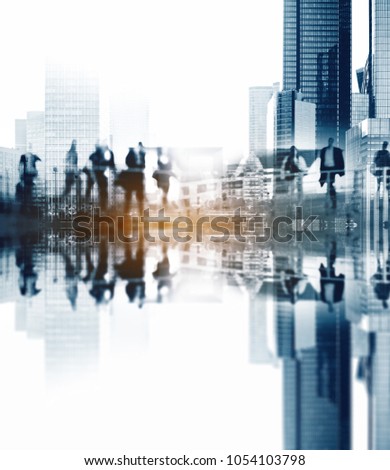 Silhouettes of people walking in the street near skyscrapers and modern office buildings in Paris business district. Multiple exposure blurred image. Economy, finances, business concept illustration.