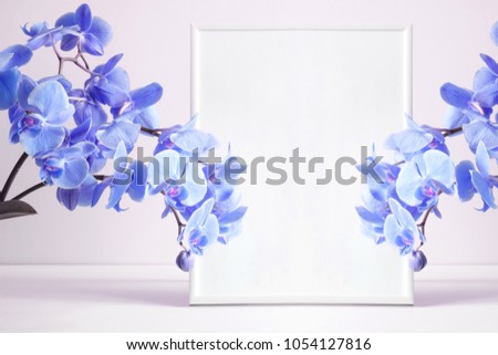 Front view blank mock up of photo frame on theon white background. Blue orchid.