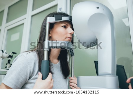 Optometrist is doing corneal topography. Corneal exam. Ophthalmology clinic. Background Royalty-Free Stock Photo #1054132115