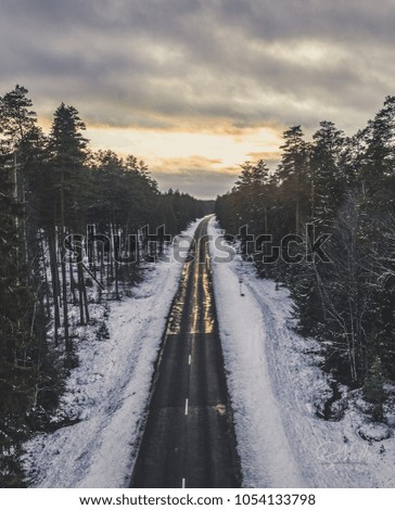 Aerial Drone Photography of a Road Surrounded with Forests in a Sunset of Winter Evening - vintage look edit