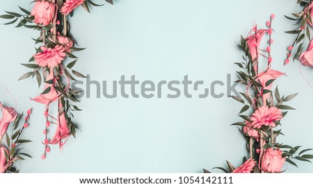 spring composition two pink, beautifully decorated spring bouquet of roses and other flowers lined with a frame on a blue background, space for text 