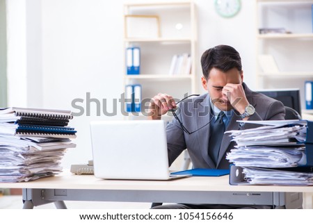 Overloaded with work employee under paperwork burden Royalty-Free Stock Photo #1054156646