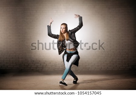 blond woman raising her arms and doing basic steps of break dance. start moving. simple moves