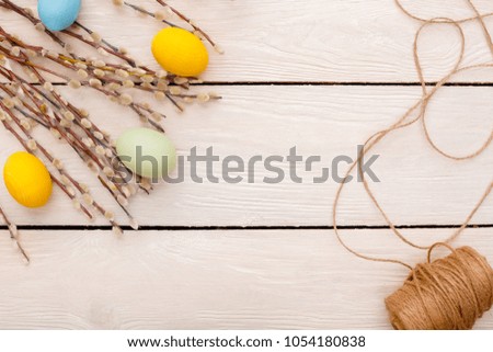 Easter traditional objects isolated on wooden background willow and eggs