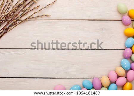 Easter traditional objects isolated on wooden background eggs and willow