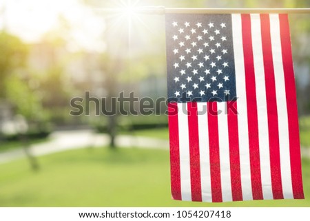American flag with bokeh natural background and sunlight for Memorial Day or 4th of July.