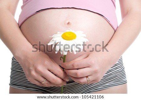 A pregnant woman in tank top and shorts posing on a white background, isolated