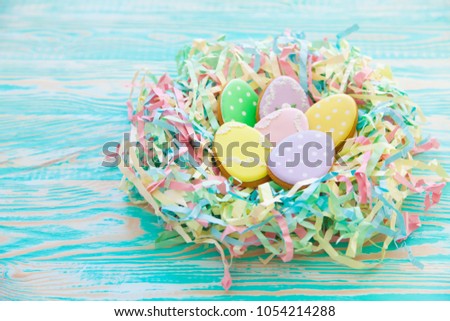 Sweets for celebrate Easter. Gingerbread in shape of easter bunny and easter eggs. White and color background top view copy space
