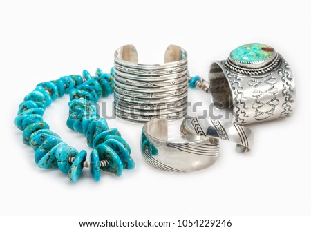  Collection of Sterling Silver Native American Bracelets with a Turquoise Nugget  Necklace with shallow depth of field.