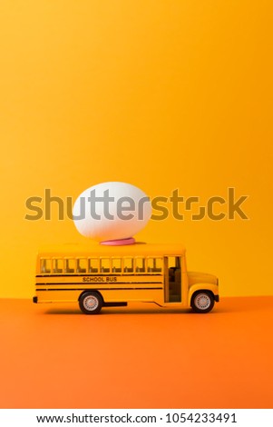 Easter egg on yellow school bus with copy space for texts.Vintage color toned for Easter concept background.